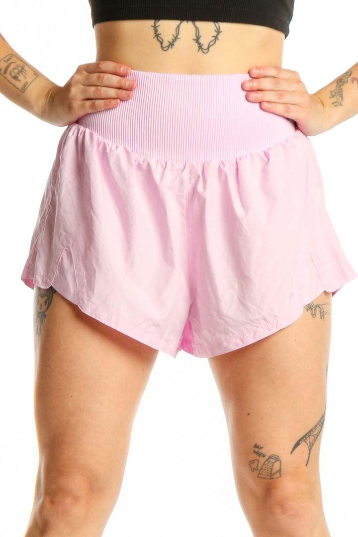 Pink ribbed waistband athletic shorts front view on model wearing black crop top