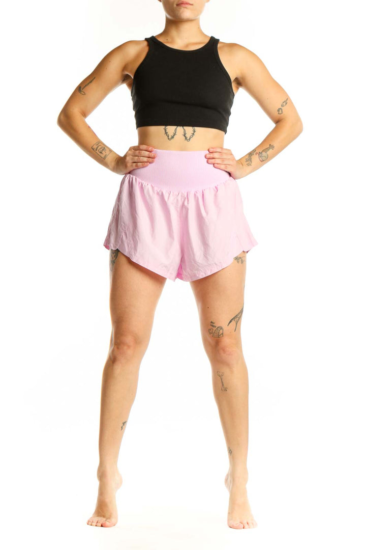 Pink ribbed waistband athletic shorts front view on model wearing black crop top