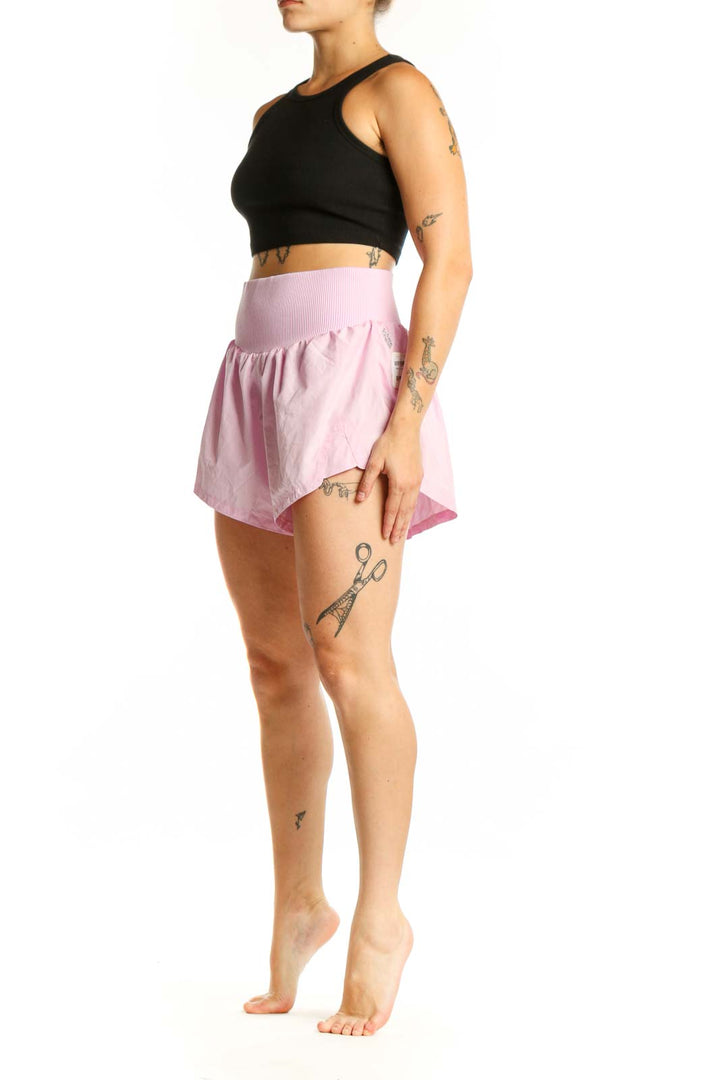 Pink ribbed waistband athletic shorts front view on model wearing black crop top