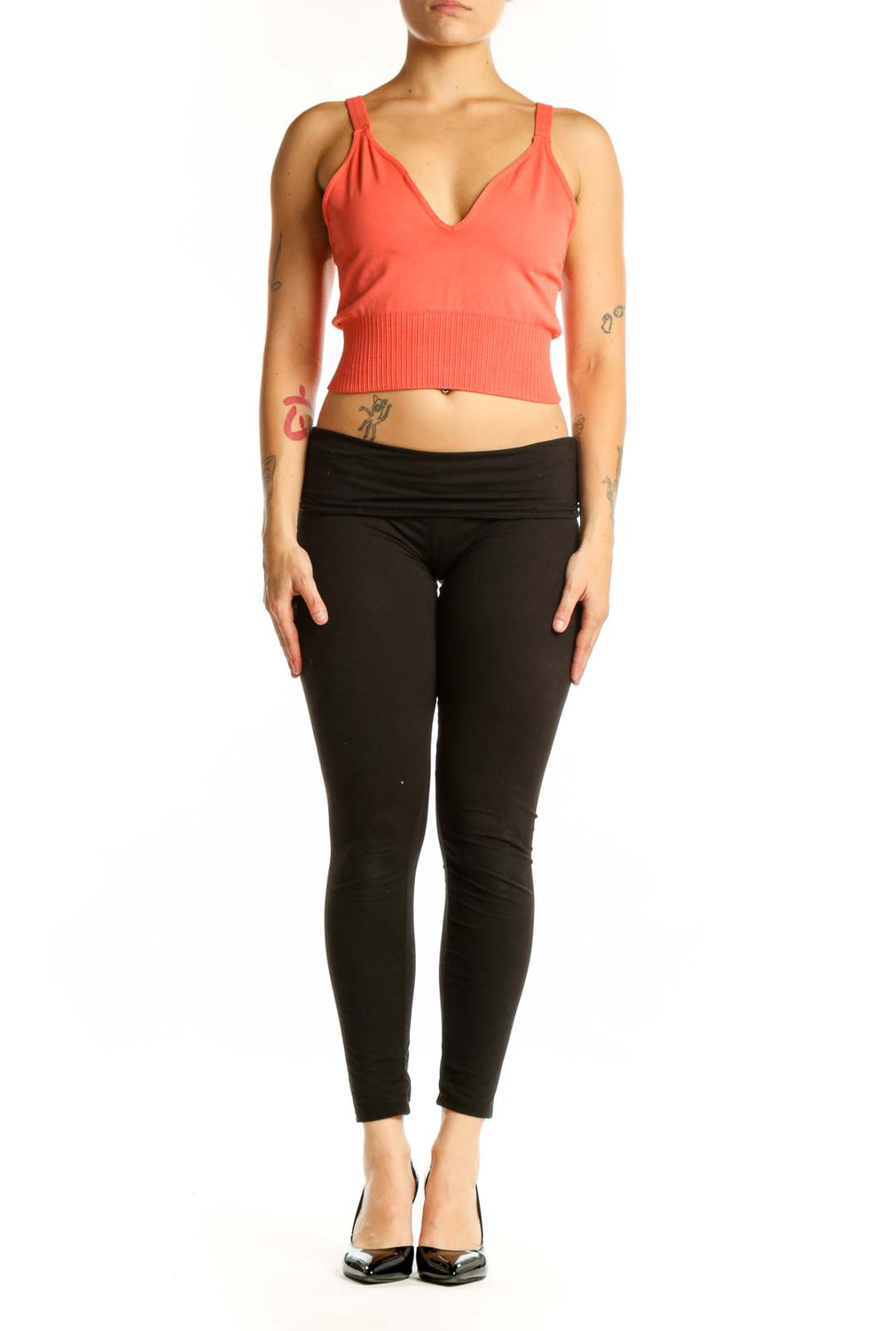 Coral ribbed crop tank top with V-neckline and black leggings, front view