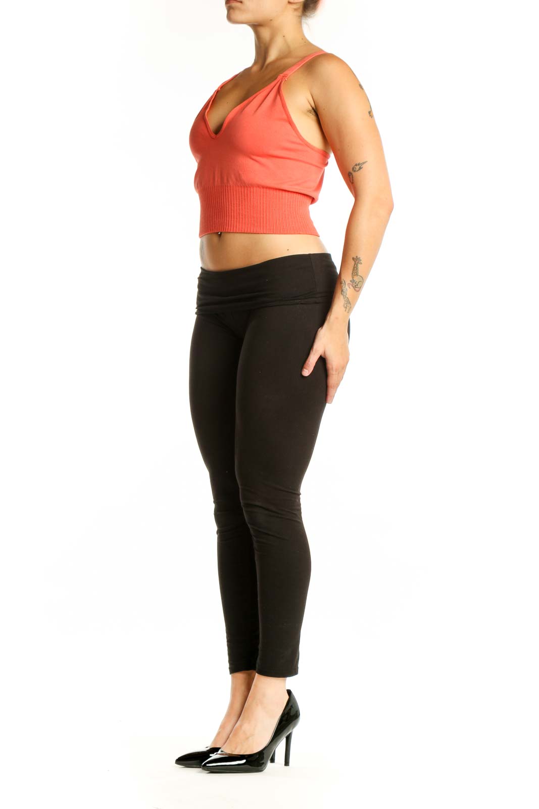 Coral ribbed crop tank top with V-neckline and black leggings, front view