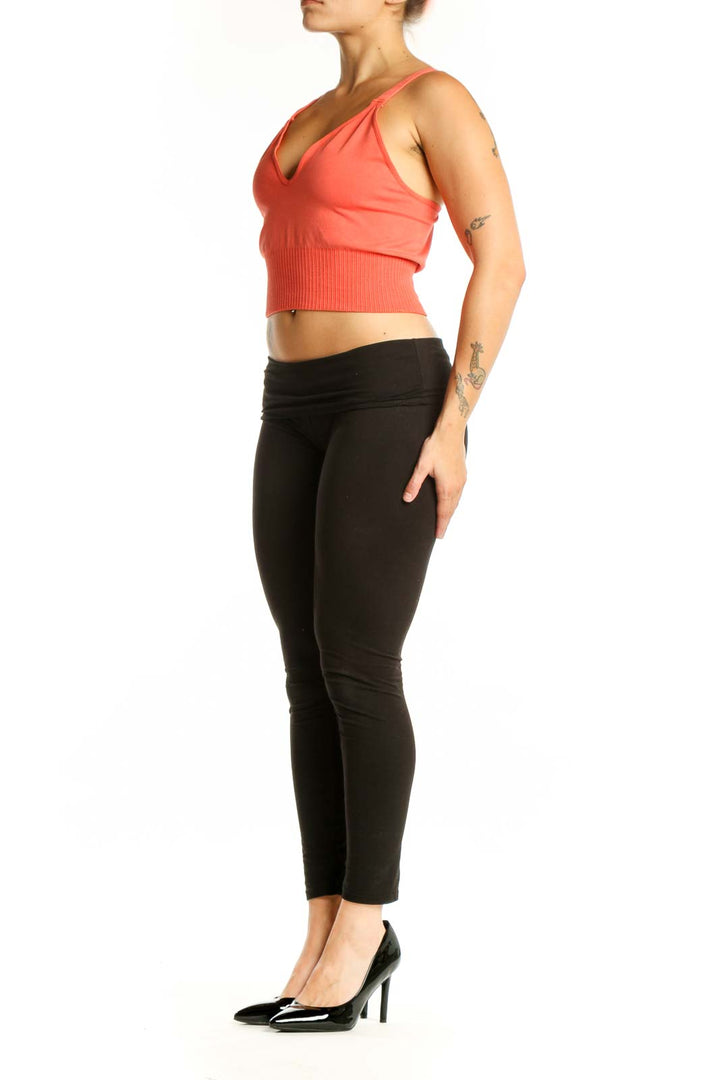 Coral ribbed crop tank top with V-neckline and black leggings, front view