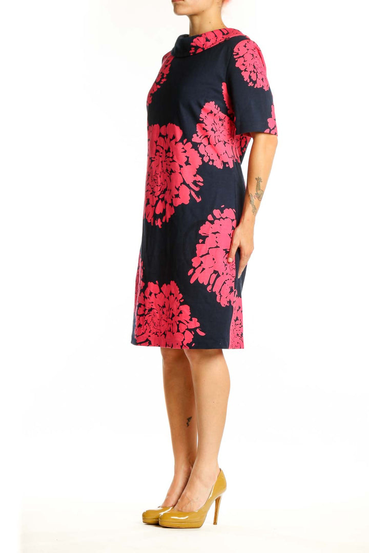 Black shift dress with vibrant pink floral print, short sleeves, crew neckline, front view