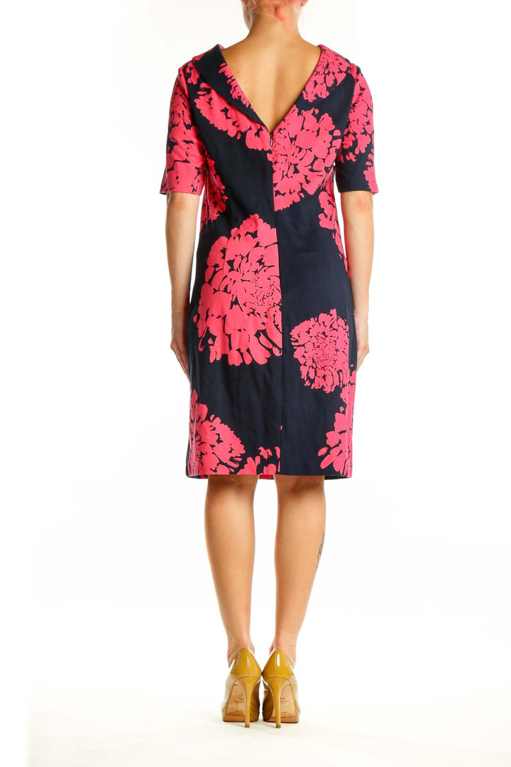 Black shift dress with pink floral pattern, back view, knee-length cut