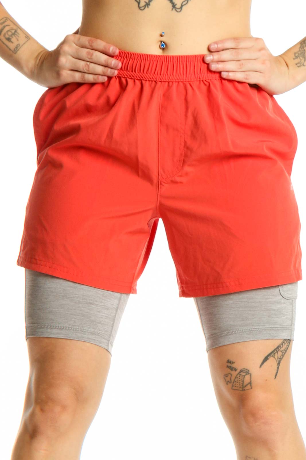 Red athletic shorts with gray compression liners, front view showing elastic waistband and functional pockets