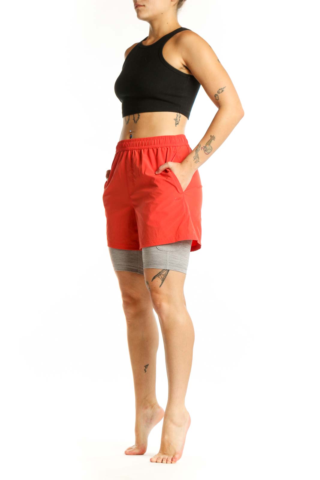 Red athletic shorts with gray compression liners, front view showing elastic waistband and functional pockets