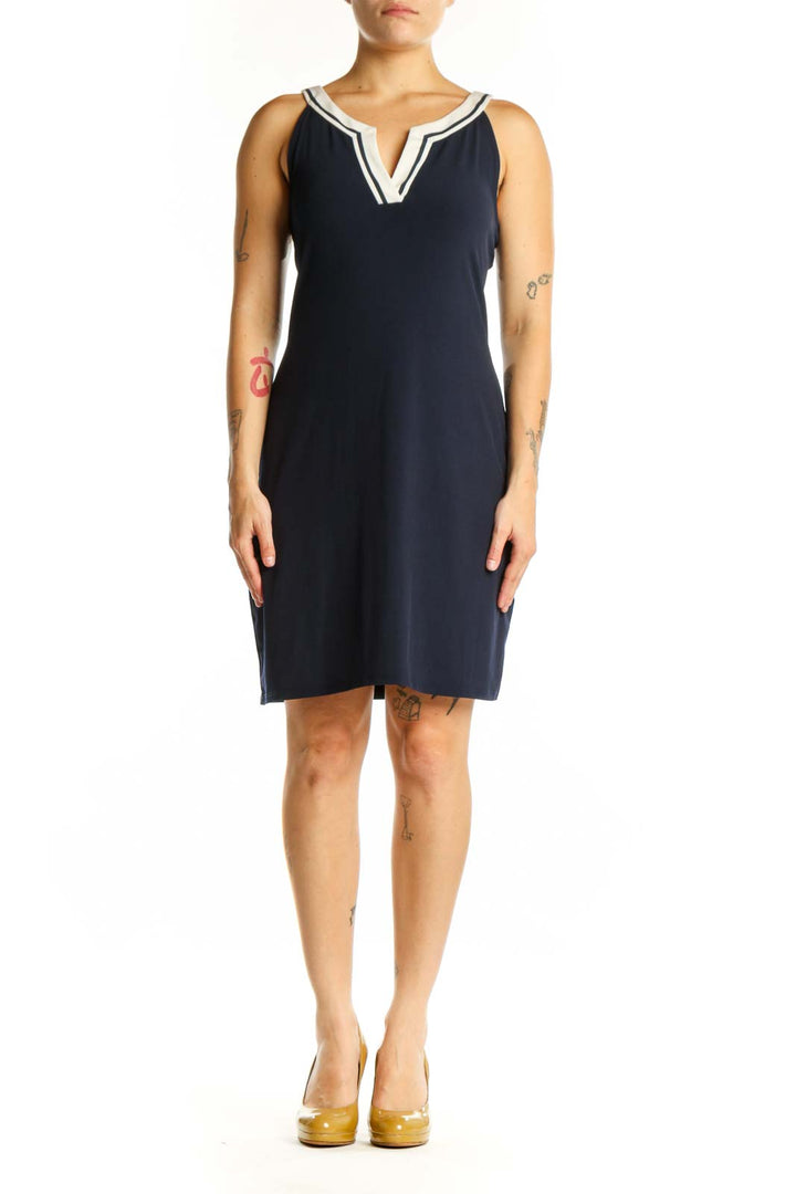 Navy sleeveless shift dress with white V-neck trim, front view