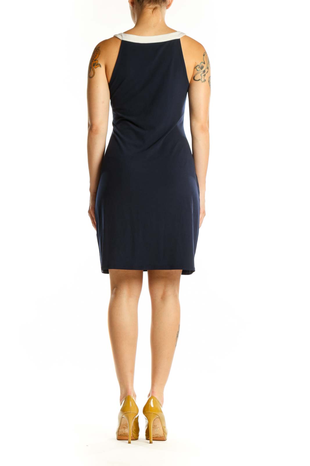 Navy sleeveless shift dress with white V-neck trim, back view