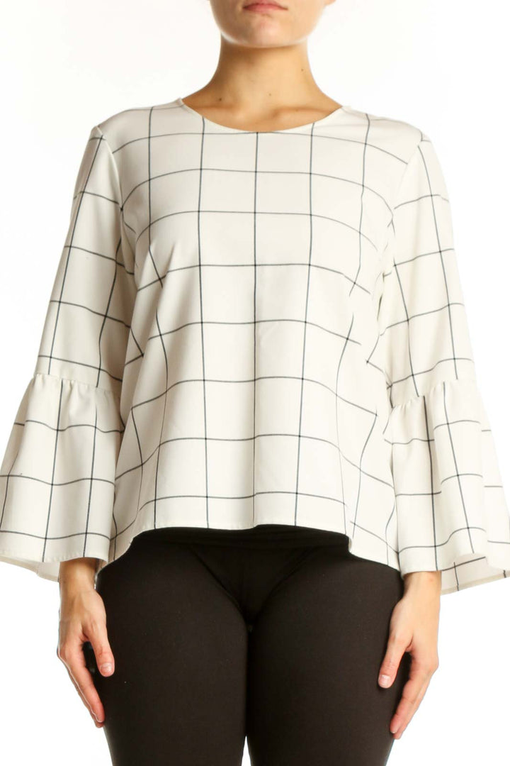 Cream grid print bell sleeve top with geometric pattern, front view on model