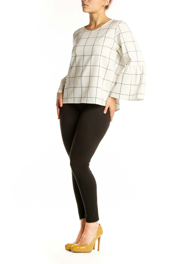 Cream grid print bell sleeve top with geometric pattern, front view on model
