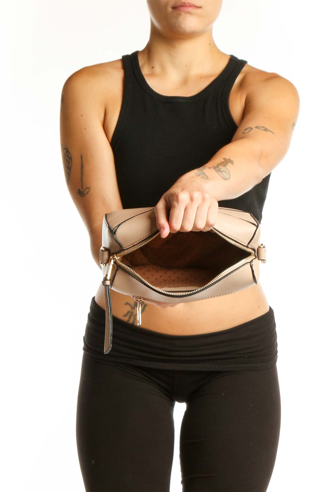 Back view of cream SilkRoll clutch bag worn as crossbody style with gold hardware details