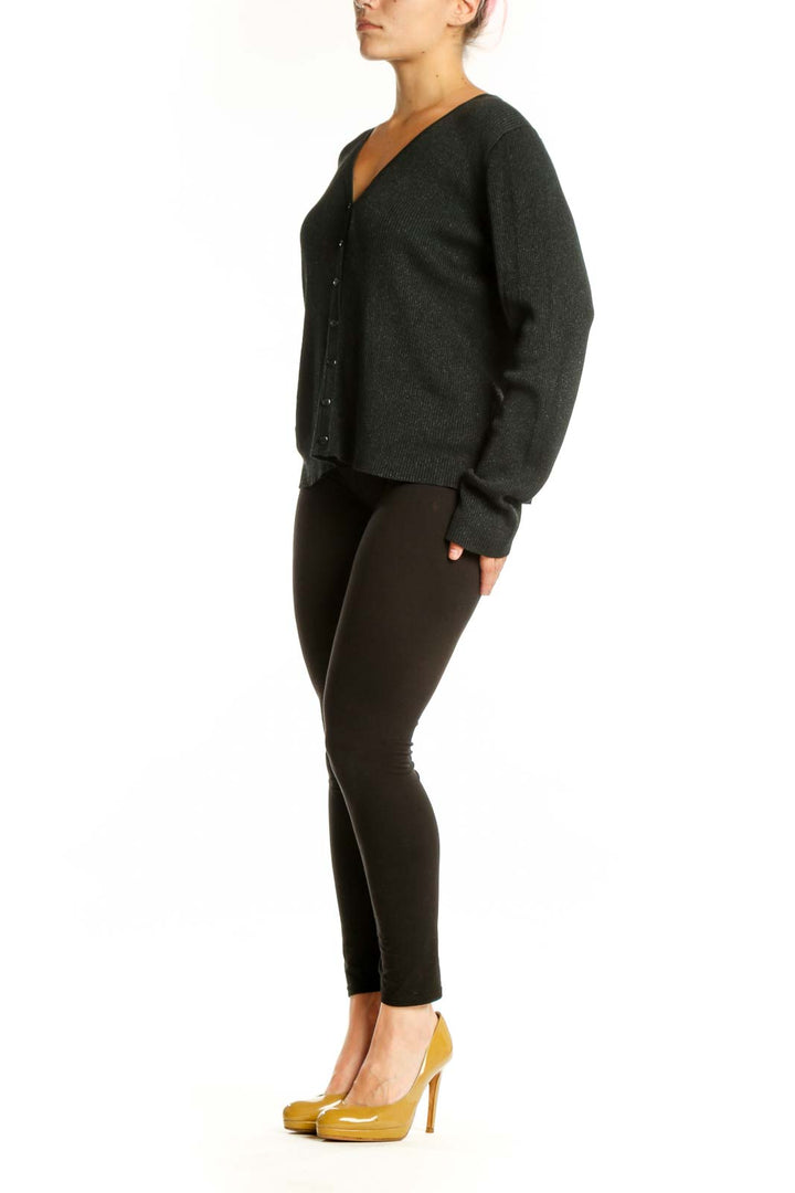 Charcoal silk lurex cardigan with V-neckline and button-front closure, worn with black pants