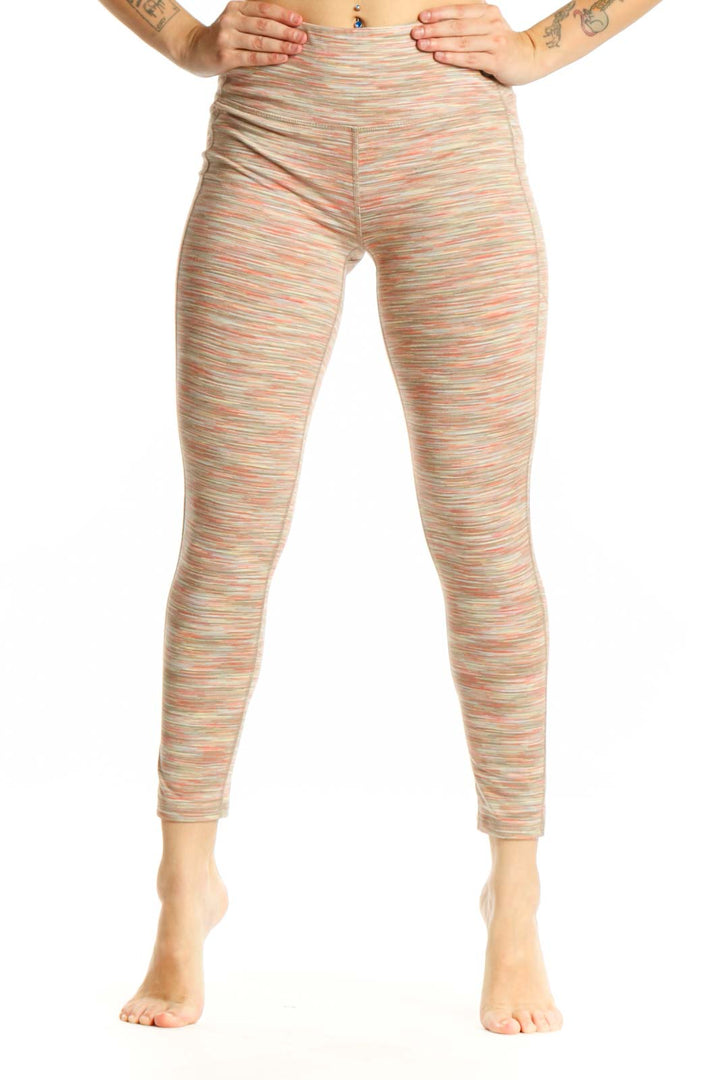 Front view of multicolor striped athletic leggings with horizontal coral, cream, and pastel stripes, high-waisted design, and cropped ankle length