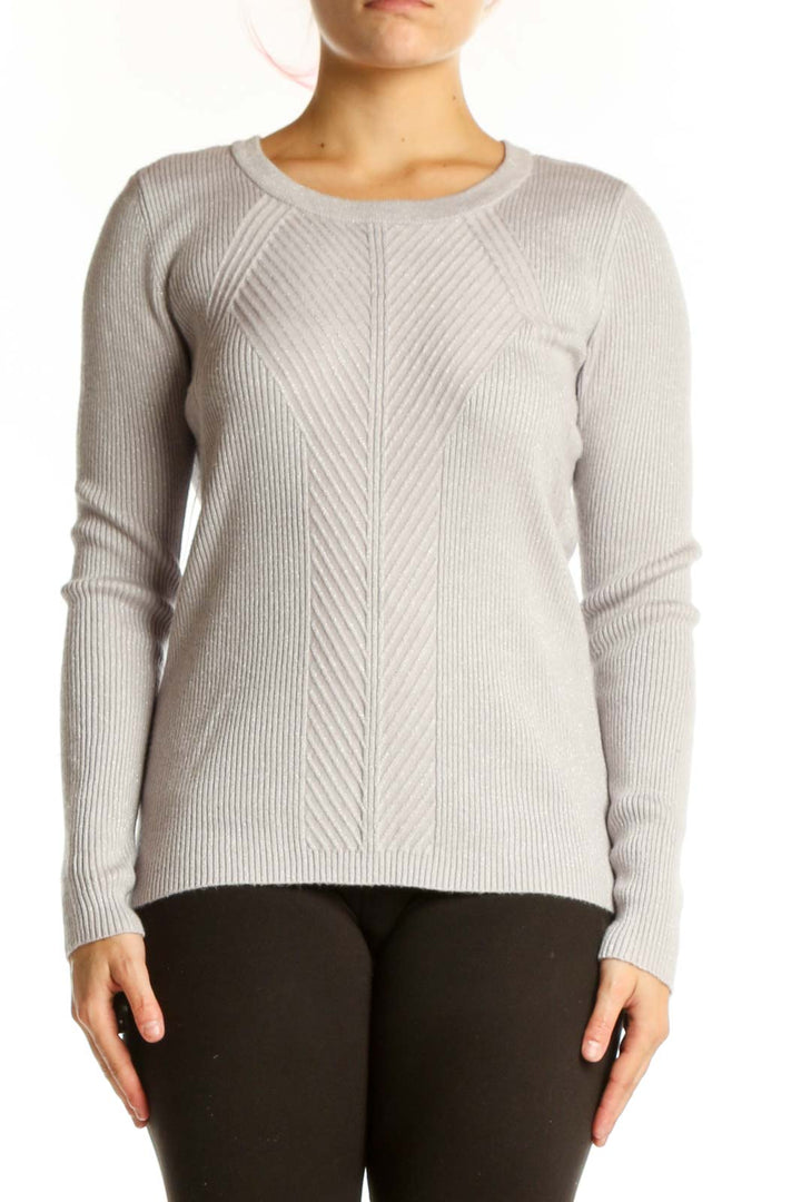 Cream ribbed knit sweater with metallic threading, crew neckline, and long sleeves on model wearing black pants