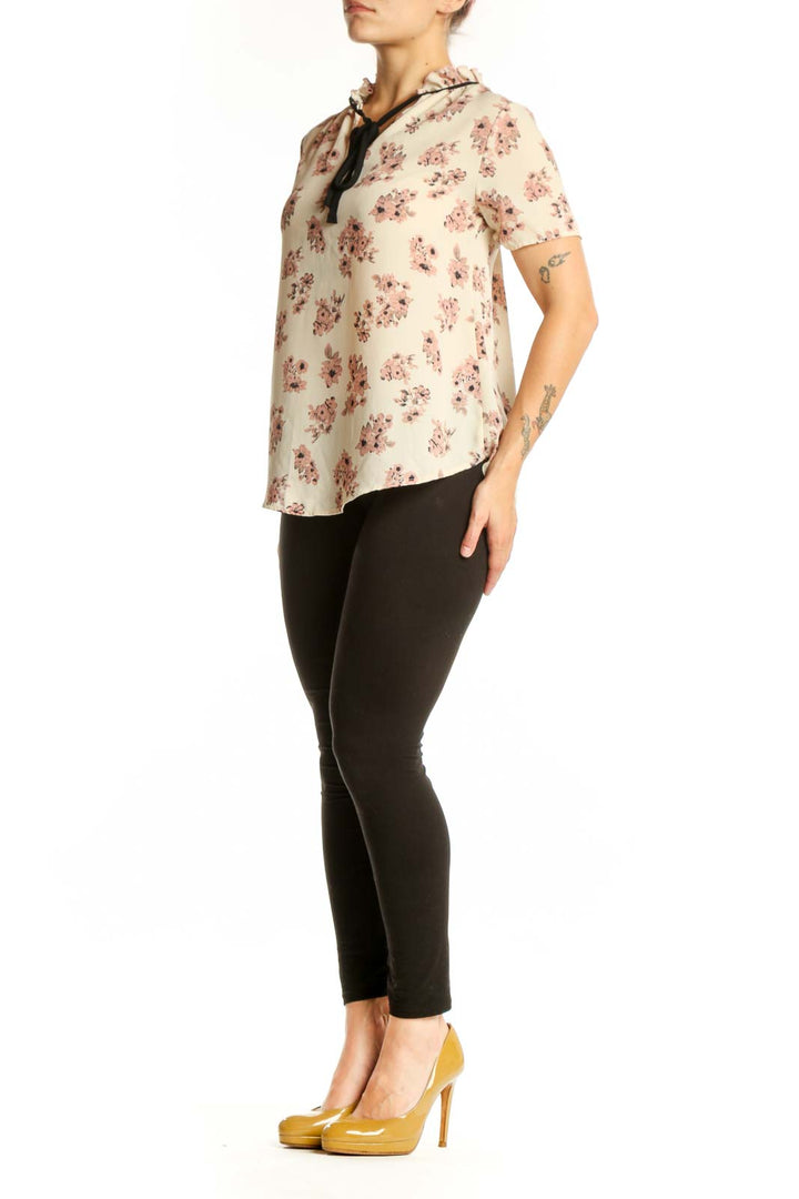SilkRoll cream floral blouse with pink flowers and black lace-up neckline detail, front view
