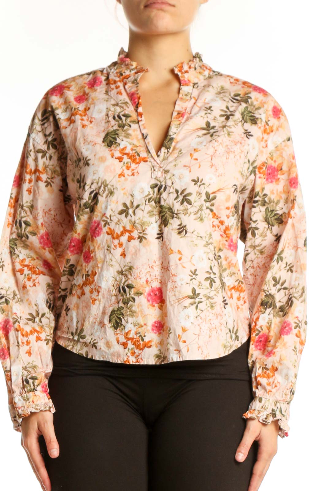 Cream floral Pima cotton button-up top by Amo with coral, pink, and sage green flowers, front view on model