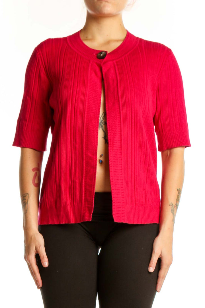 Red ribbed knit cardigan with button-front closure and three-quarter sleeves, worn open over black pants