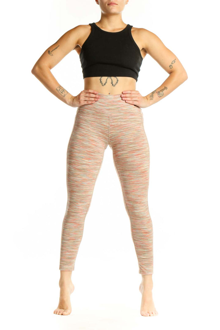 Front view of multicolor striped high-waist yoga leggings by DSG in size small, showing vibrant horizontal stripes and high-waist design