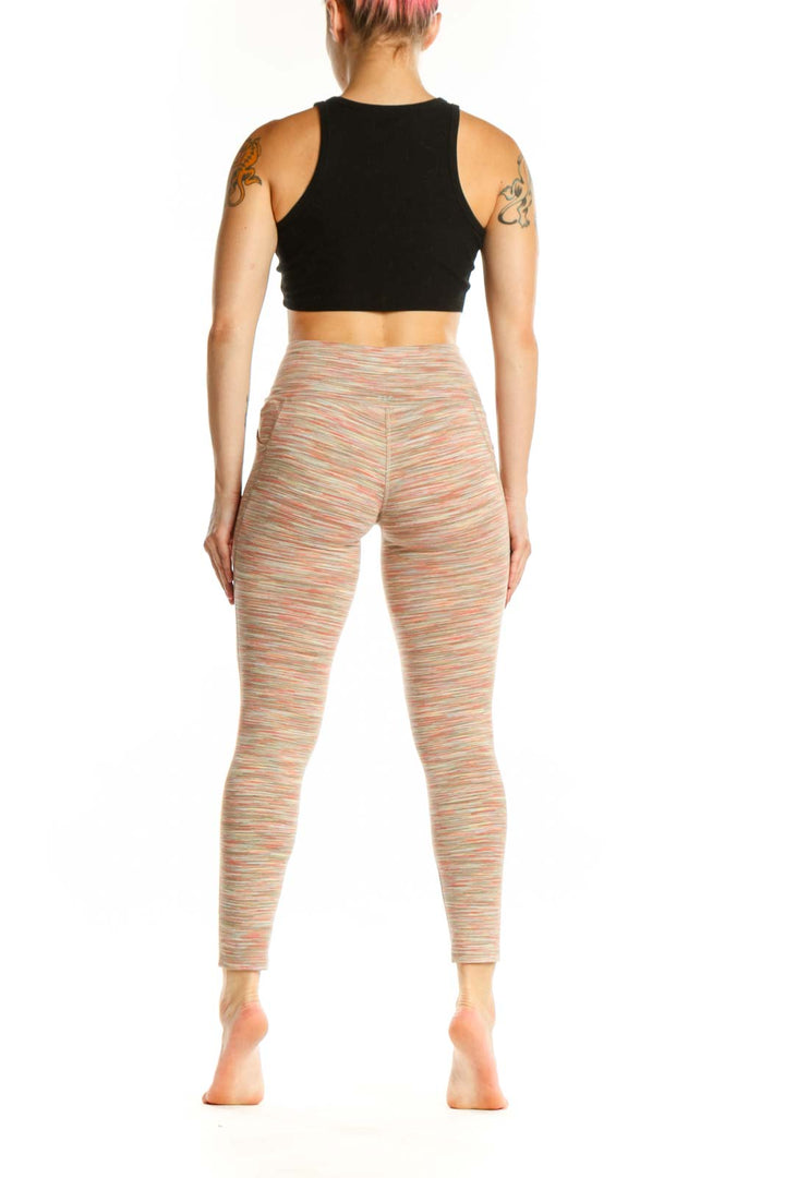 Back view of multicolor striped high-waist yoga leggings by DSG, displaying the striped pattern and form-fitting silhouette