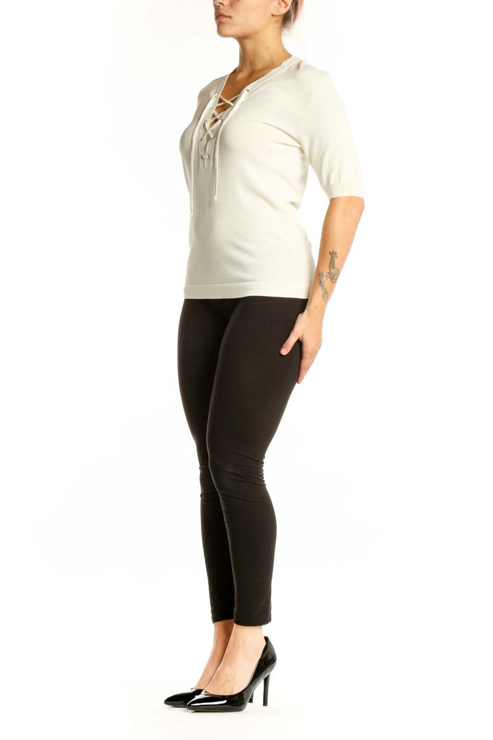 Cream lace-up V-neck top with three-quarter sleeves, front view on model