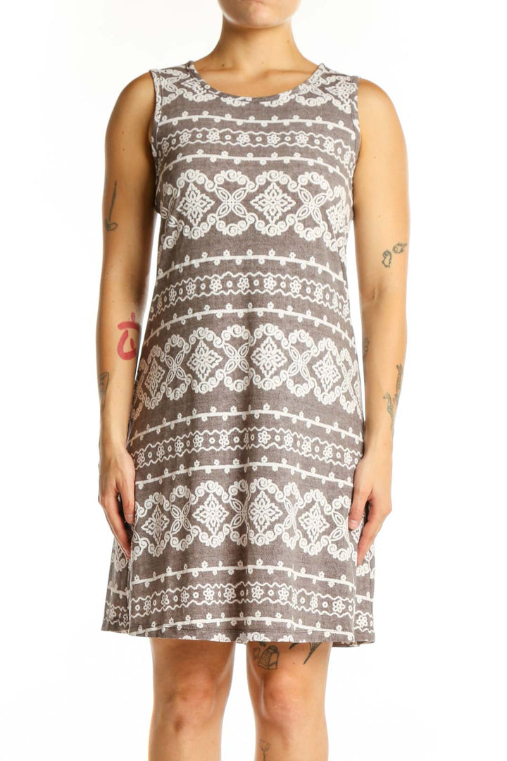 Front view of taupe geometric print A-line dress with cream and white diamond motifs, sleeveless crew neckline design