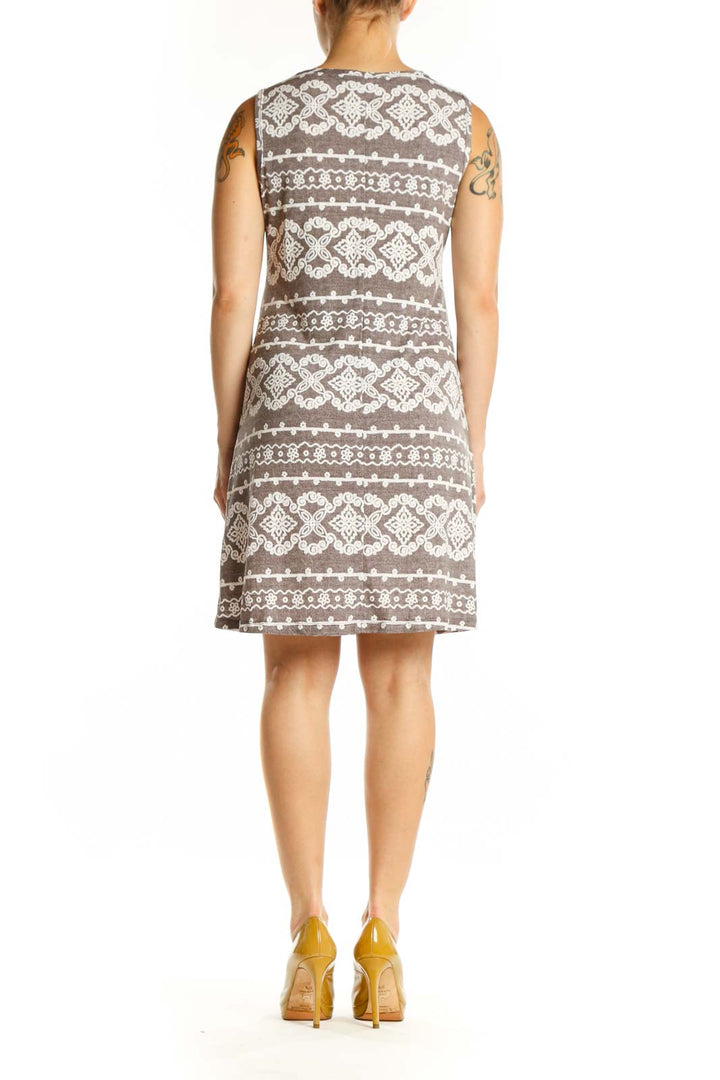 Back view of taupe geometric print A-line dress showing full ornamental pattern and relaxed A-line silhouette