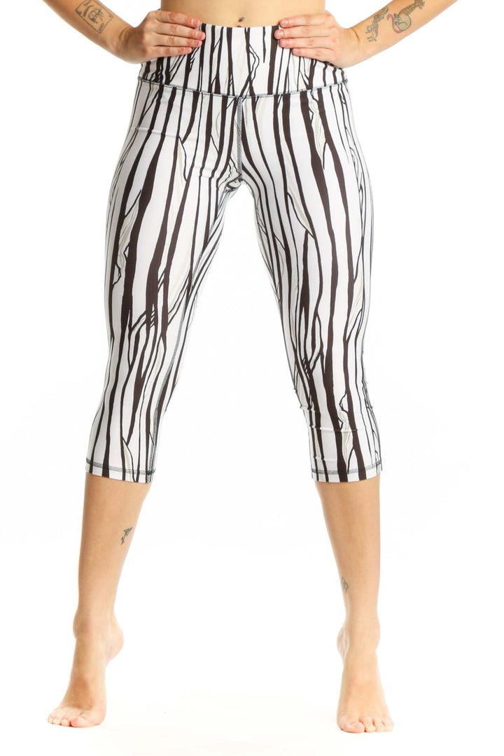 White and black striped DSG capri leggings with high-waisted design, front view
