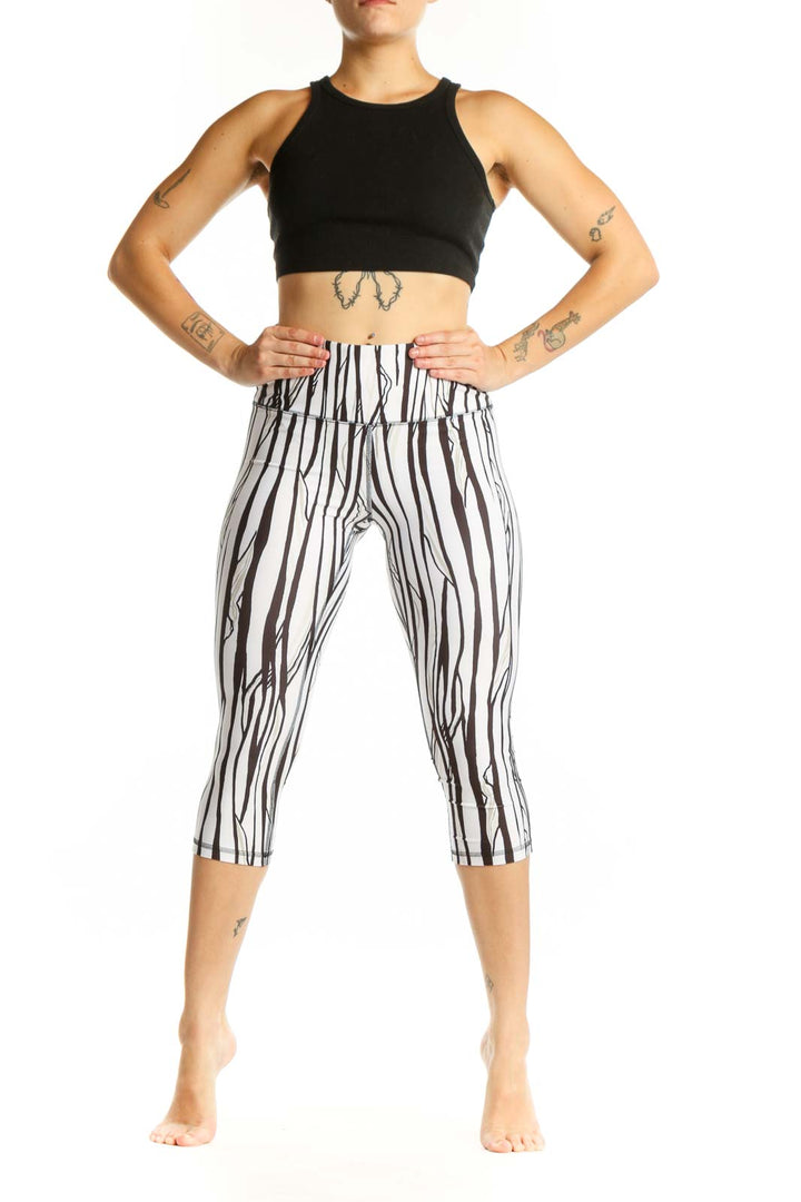 White and black striped DSG capri leggings with high-waisted design, front view
