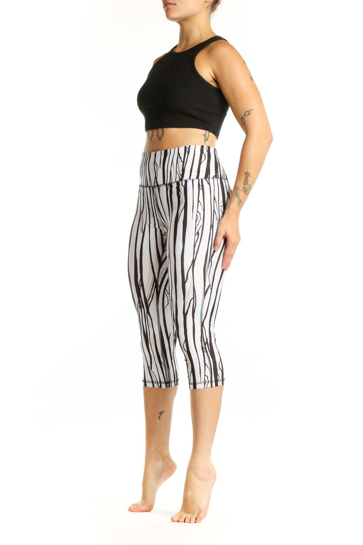 White and black striped DSG capri leggings with high-waisted design, front view