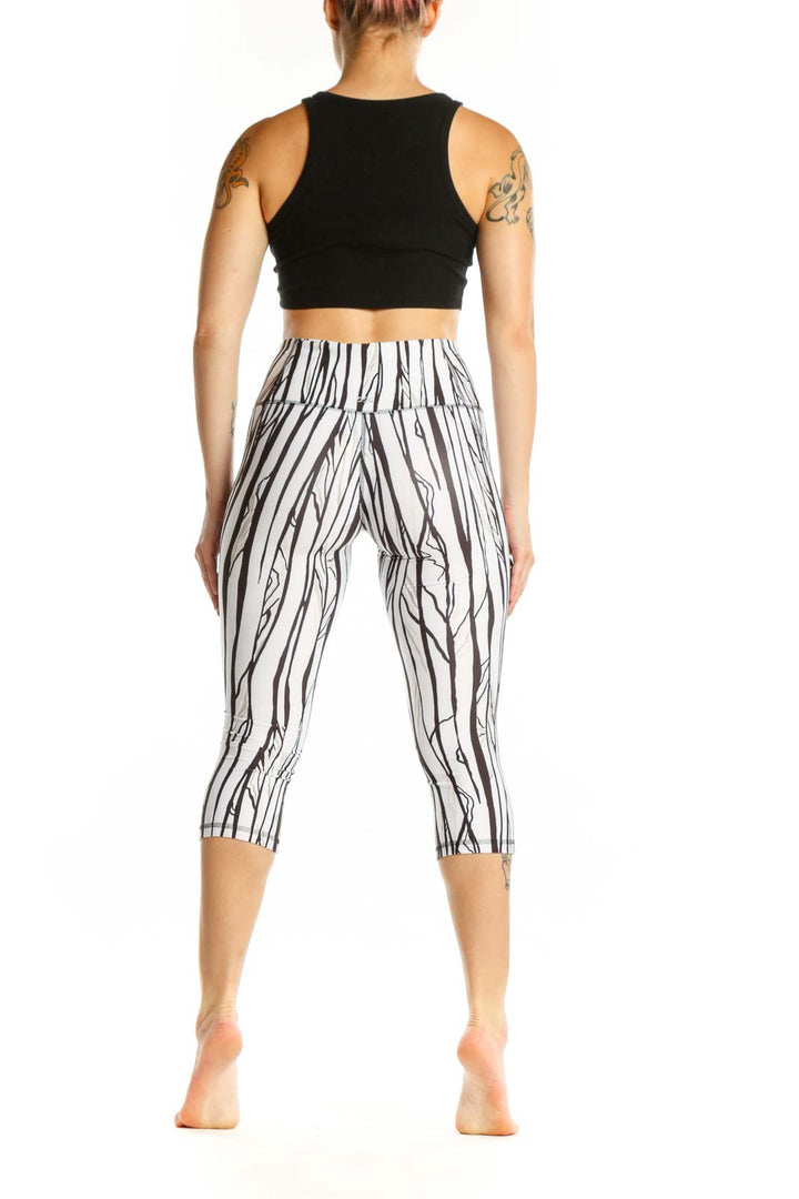 White and black striped DSG capri leggings with high-waisted design, side view