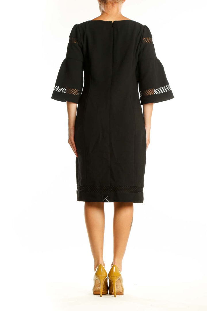 Black bell sleeve lace dress with mesh detailing, back view on model