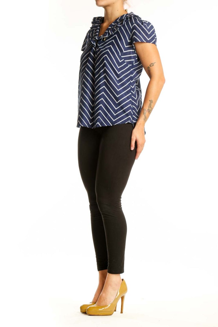 Navy and white chevron striped short sleeve top with V-neckline and tie detail, front view