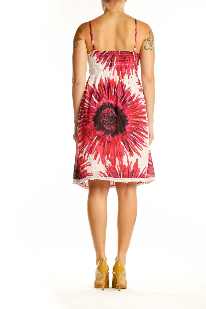 Back view of red floral midi dress showing empire waist ruching and lace-trimmed hem