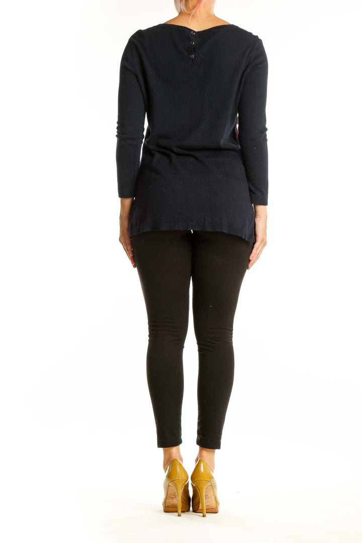 Red dachshund print knit pullover with black long sleeves, back view on model