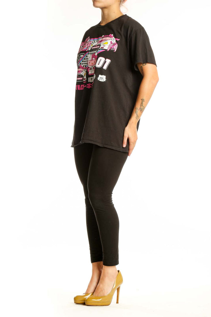 Black Hello Kitty racing graphic t-shirt front view with vibrant pink neon design, racing car illustration, and Japanese characters