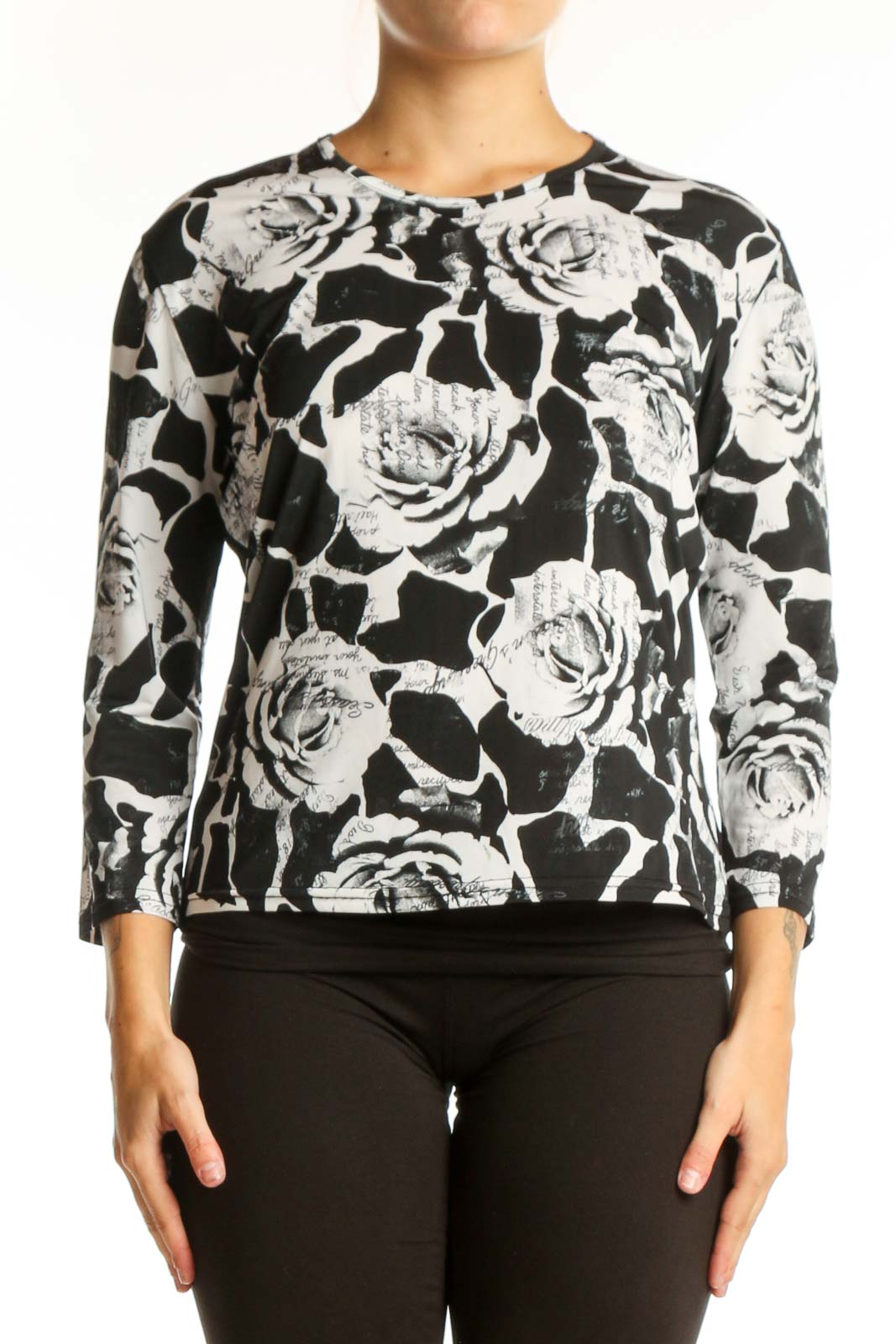 Black and white floral rose print top with three-quarter sleeves, front view on model