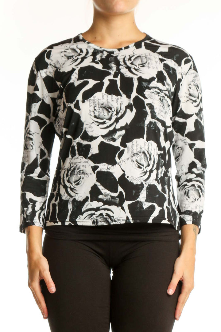 Black and white floral rose print top with three-quarter sleeves, front view on model