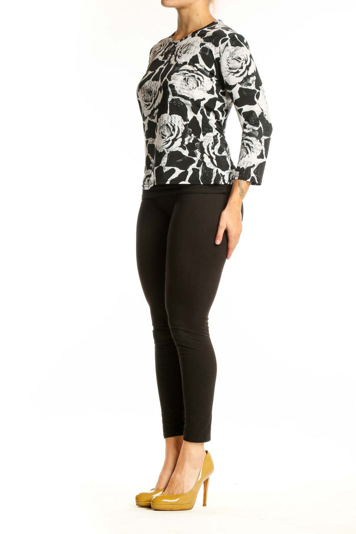 Black and white floral rose print top with three-quarter sleeves, front view on model