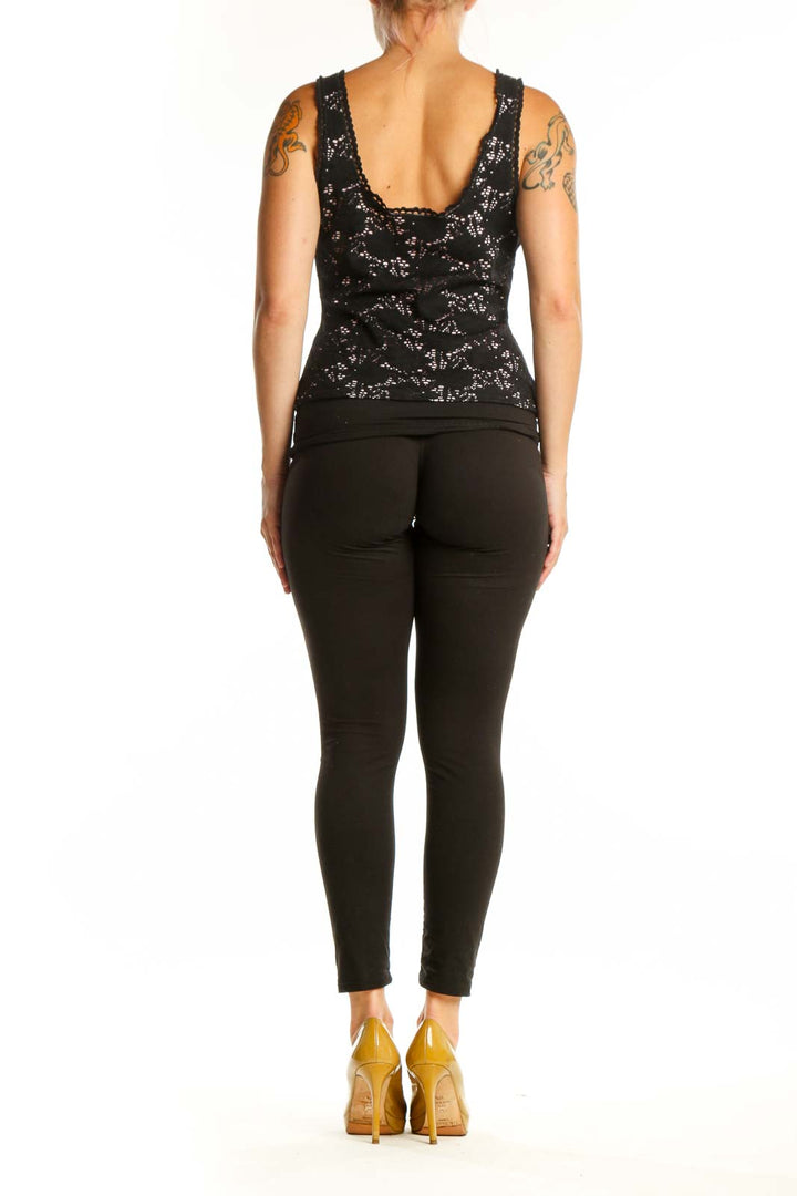 Black lace tank top with ruffle shoulders, back view showing fitted silhouette