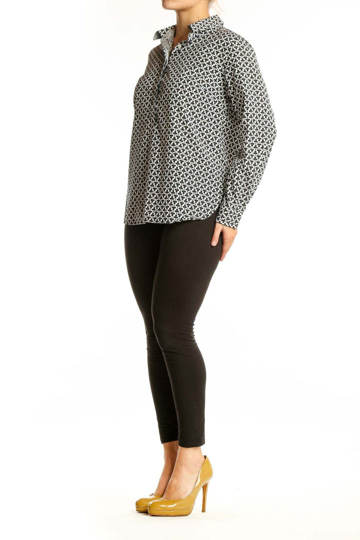 Black and white geometric print button-up shirt with collar and long sleeves, front view