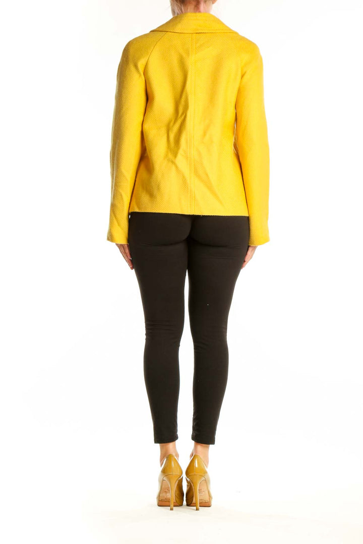 Back view of yellow tailored blazer showing cropped length and structured silhouette