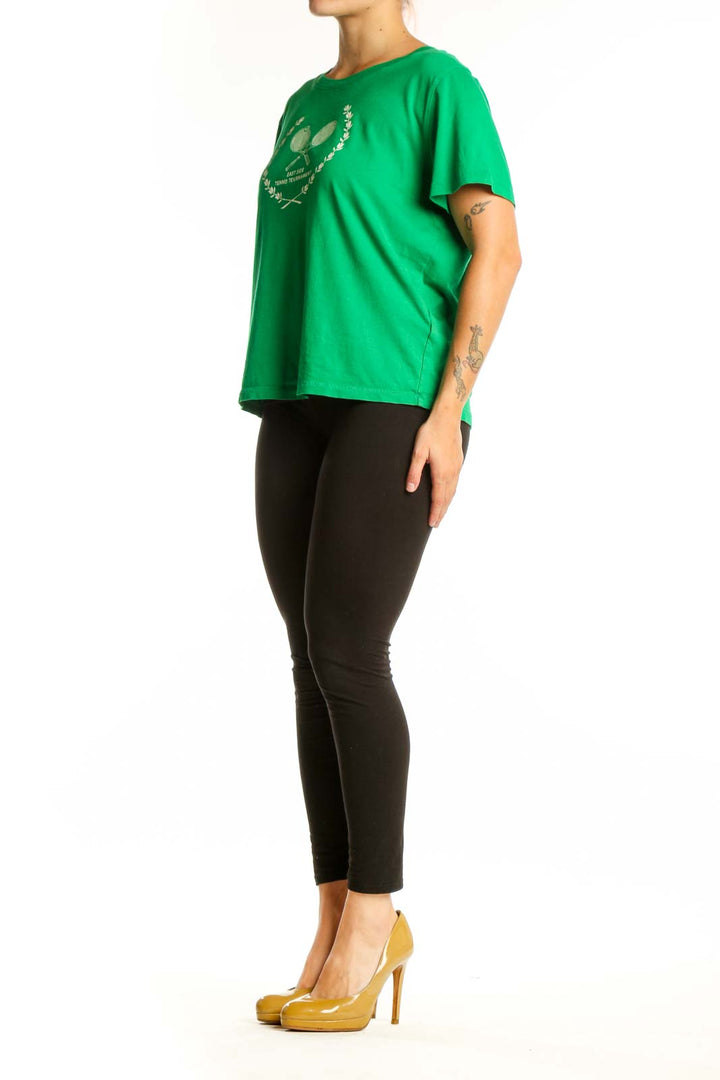 Green J.Crew t-shirt with white tennis racket and laurel wreath graphic design, front view