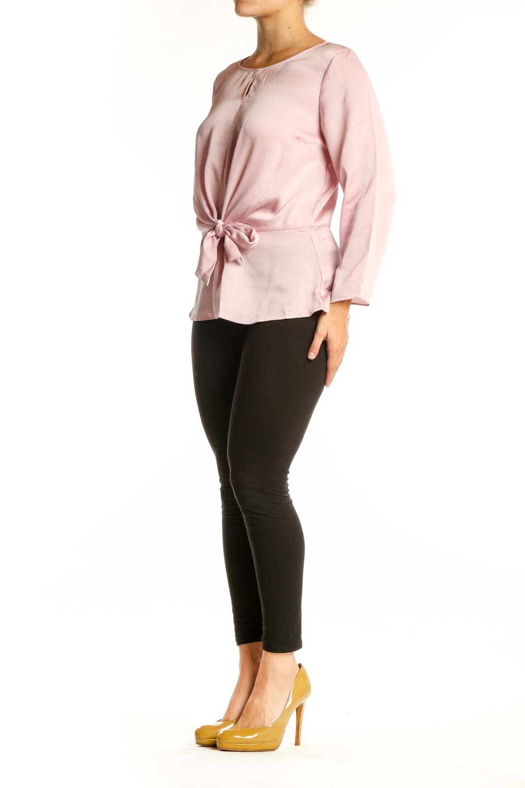 Pink tie-front long sleeve blouse with crew neckline, front view on model