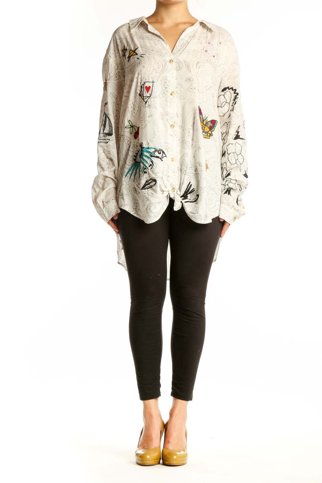 Cream Pilcro rayon shirt with whimsical embroidered birds, butterflies, hearts, and line drawings on front, worn with black leggings