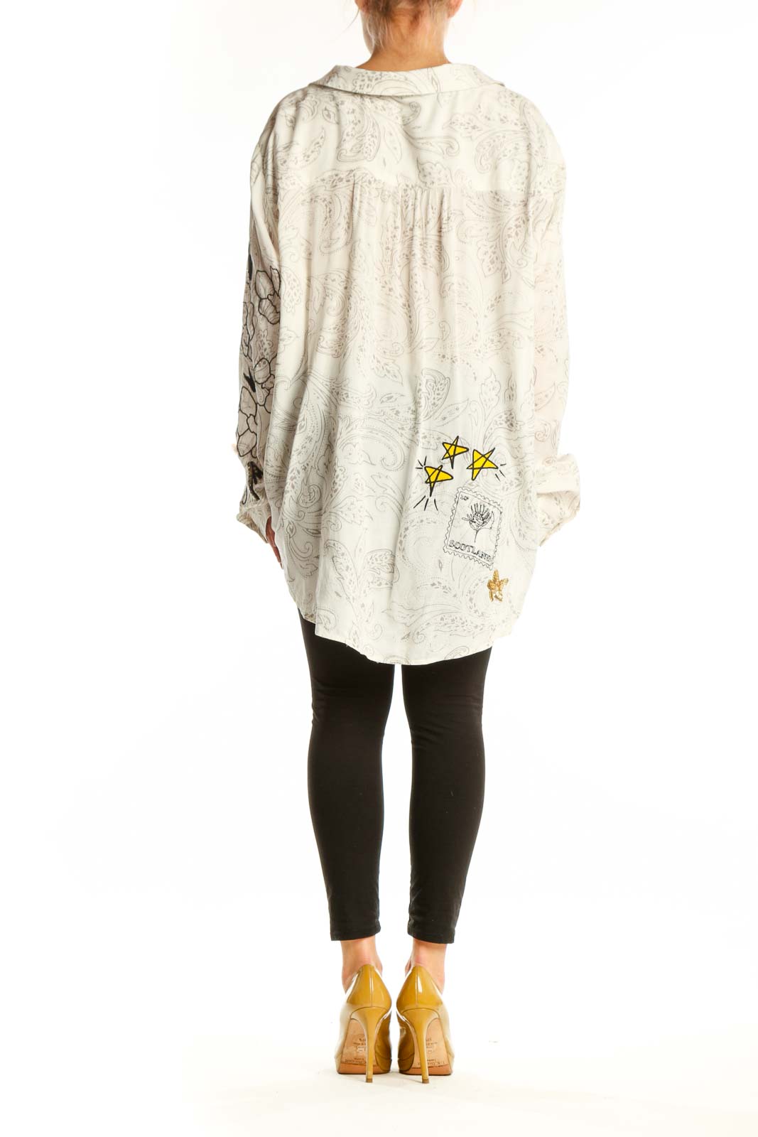 Back view of cream Pilcro embroidered rayon shirt showing scattered whimsical motifs and button-up closure
