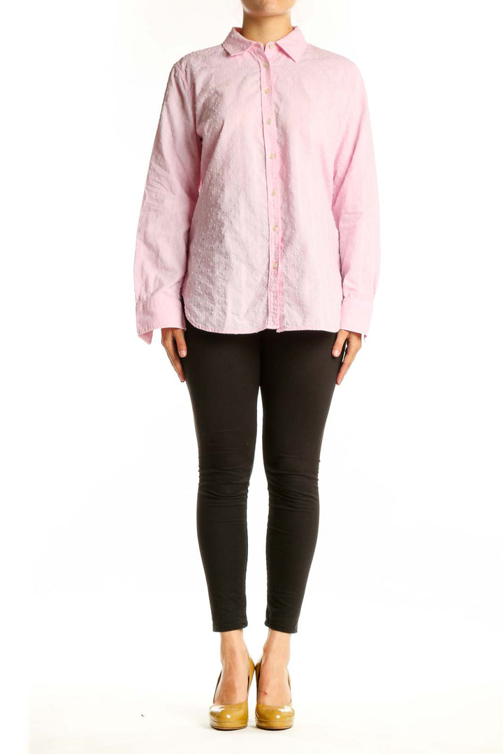 Pink cotton button-down shirt with collared neckline and long sleeves, displayed on model