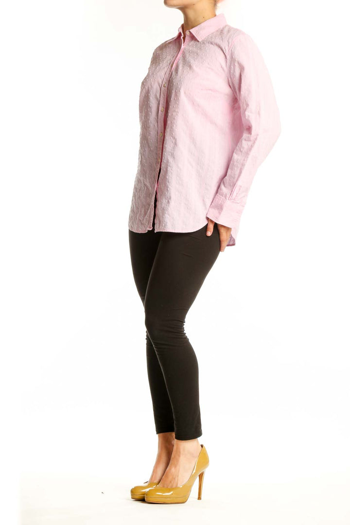 Pink cotton button-down shirt with collared neckline and long sleeves, displayed on model