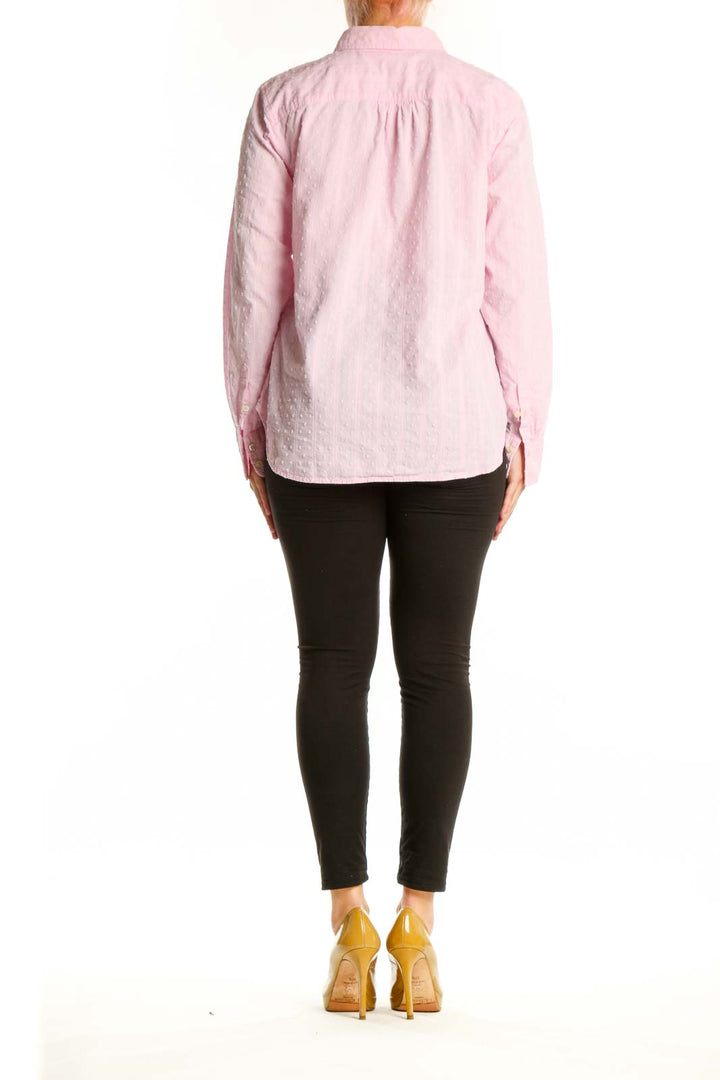 Back view of pink cotton button-down shirt showing relaxed fit and full-length sleeves