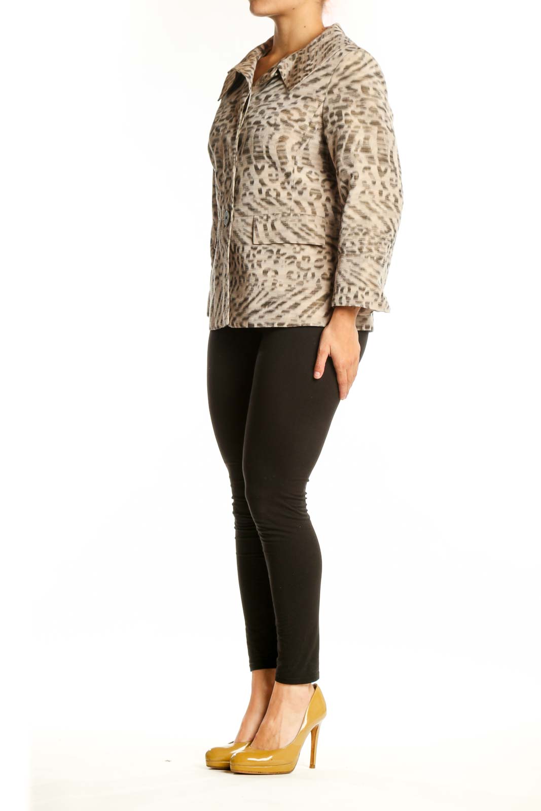 Beige leopard print button-up jacket with collared neckline and tailored waist, worn with black pants