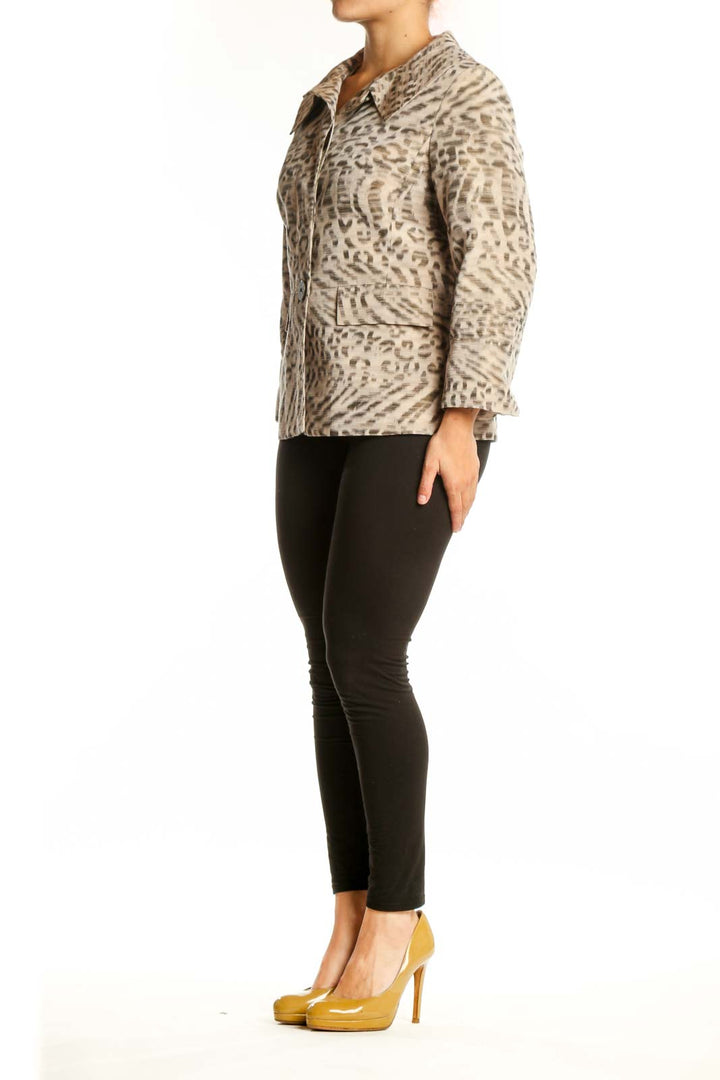 Beige leopard print button-up jacket with collared neckline and tailored waist, worn with black pants